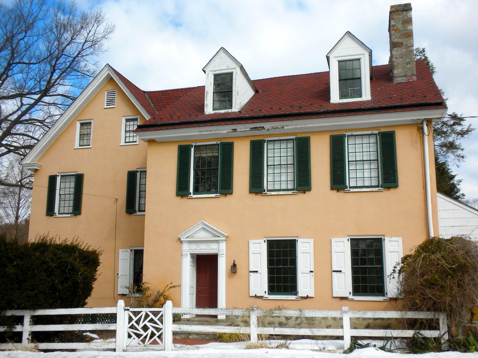 Roughwood, a two-story historic house with green shutters and dormers on Old Lancaster Road in Devon
