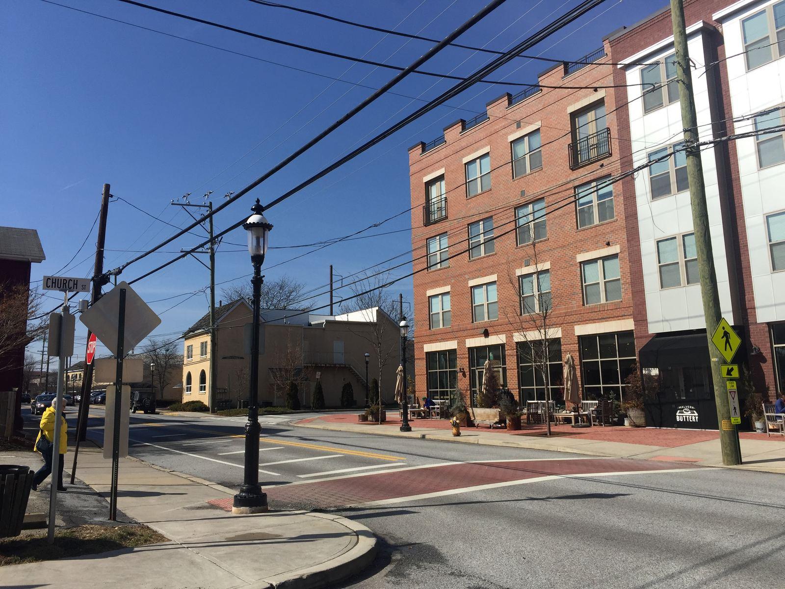 King Street in downtown Malvern with brick mixed-use buildings and street lamps